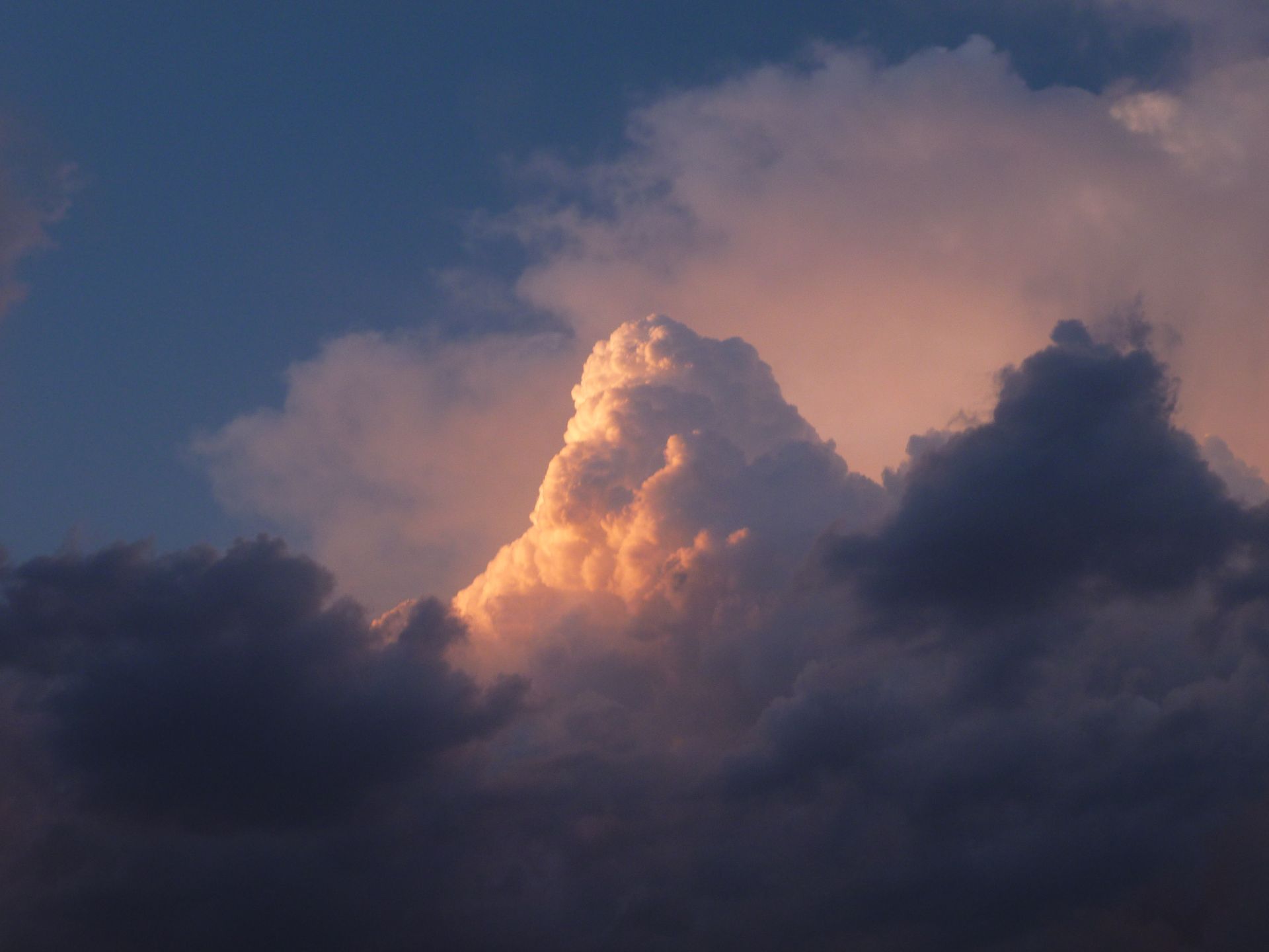 Dramatic clouds illuminated by sunset colors.